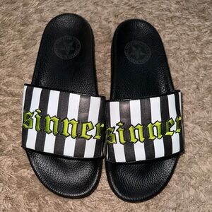 Black craft “Sinner” slip ons